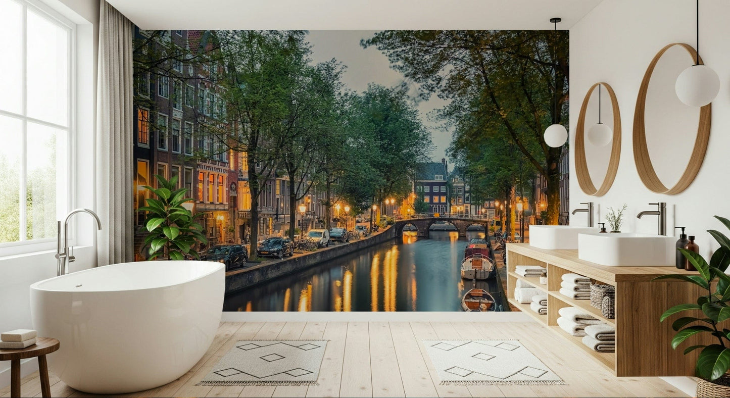 Amsterdam Canal Lights wallpaper mural of an evening canal behind a white tub and wood vanity in a bright bathroom