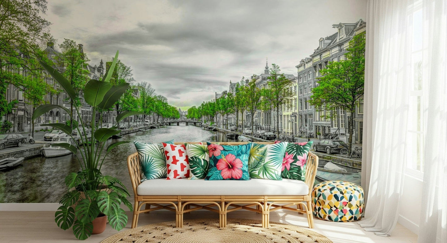 Amsterdam Canal Serenity wallpaper mural of a leafy canal behind a rattan sofa with tropical-print pillows in a sunroom