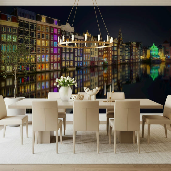 Amsterdam Nights City Lights wallpaper mural of lit canal houses behind a long cream dining table and beige chairs