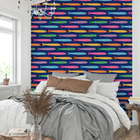 Rainbow fish swimming across royal blue wallpaper for a joyful look.

