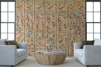Ancient Glyphs wallpaper mural of Egyptian carvings between two white armchairs and a round wood table in a living room