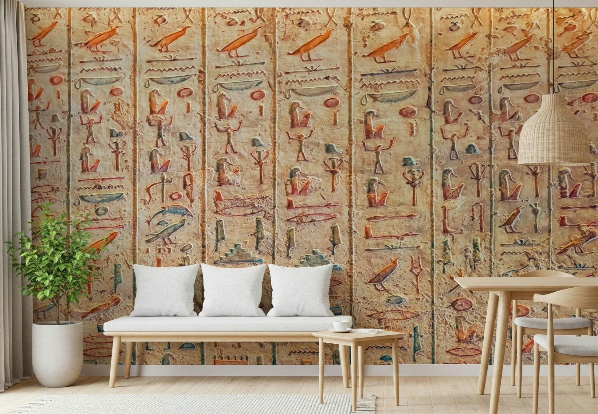 Ancient Glyphs wallpaper mural of stone hieroglyph carvings behind a white bench and potted plant in a living space
