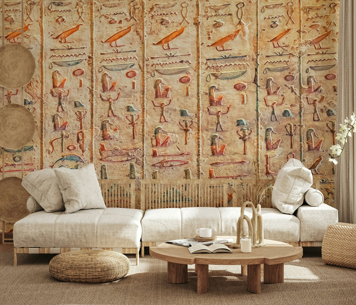 Ancient Glyphs wallpaper mural of orange hieroglyph carvings behind a cream low sofa in a living room