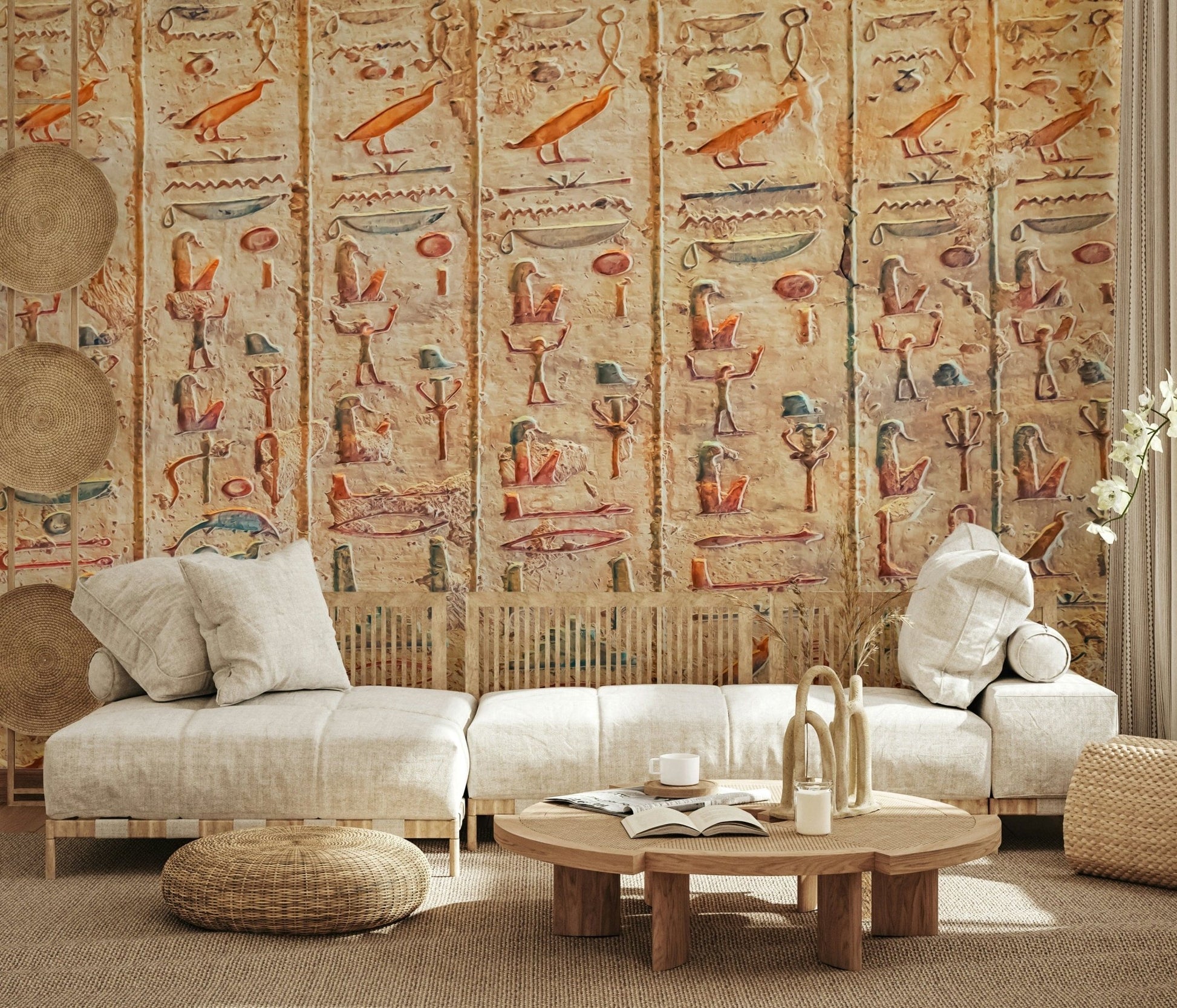 Ancient Glyphs wallpaper mural of orange hieroglyph carvings behind a cream low sofa in a living room