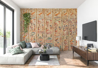 Ancient Glyphs wallpaper mural of carved hieroglyphs behind a grey sectional and wood TV console in a living room