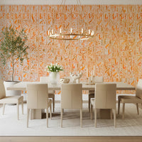 Ancient Inscriptions wallpaper mural in orange glyphs in an elegant dining room with beige chairs and a round chandelier