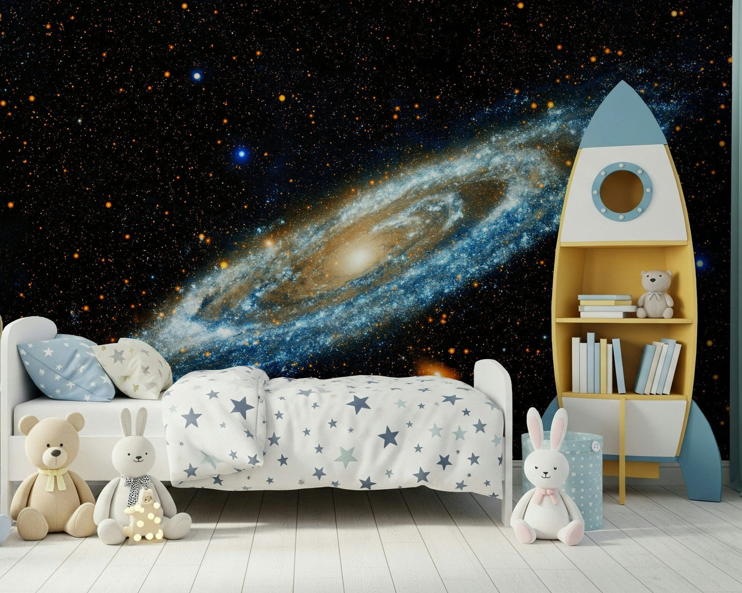 Andromeda mural of a glowing spiral galaxy behind a star-print kids bed and blue rocket bookshelf