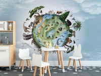 Animals Around Earth wallpaper with an animal-covered globe above a white play kitchen and bunny chairs in a kids room