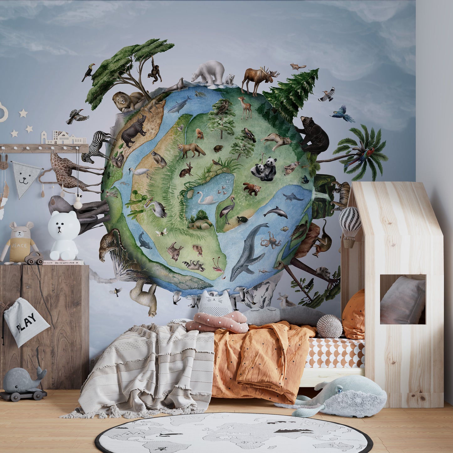 Animals Around Earth wallpaper showing a globe ringed with wildlife above a wooden house-frame bed in a kids room