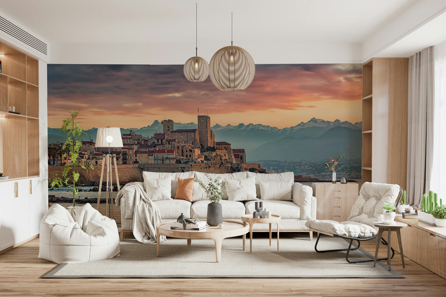 Twilight mural capturing the warm glow over Antibes’ coastal stone structures and mountains beyond.