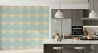 Repeating pattern of textured aqua round shapes on a warm neutral backdrop