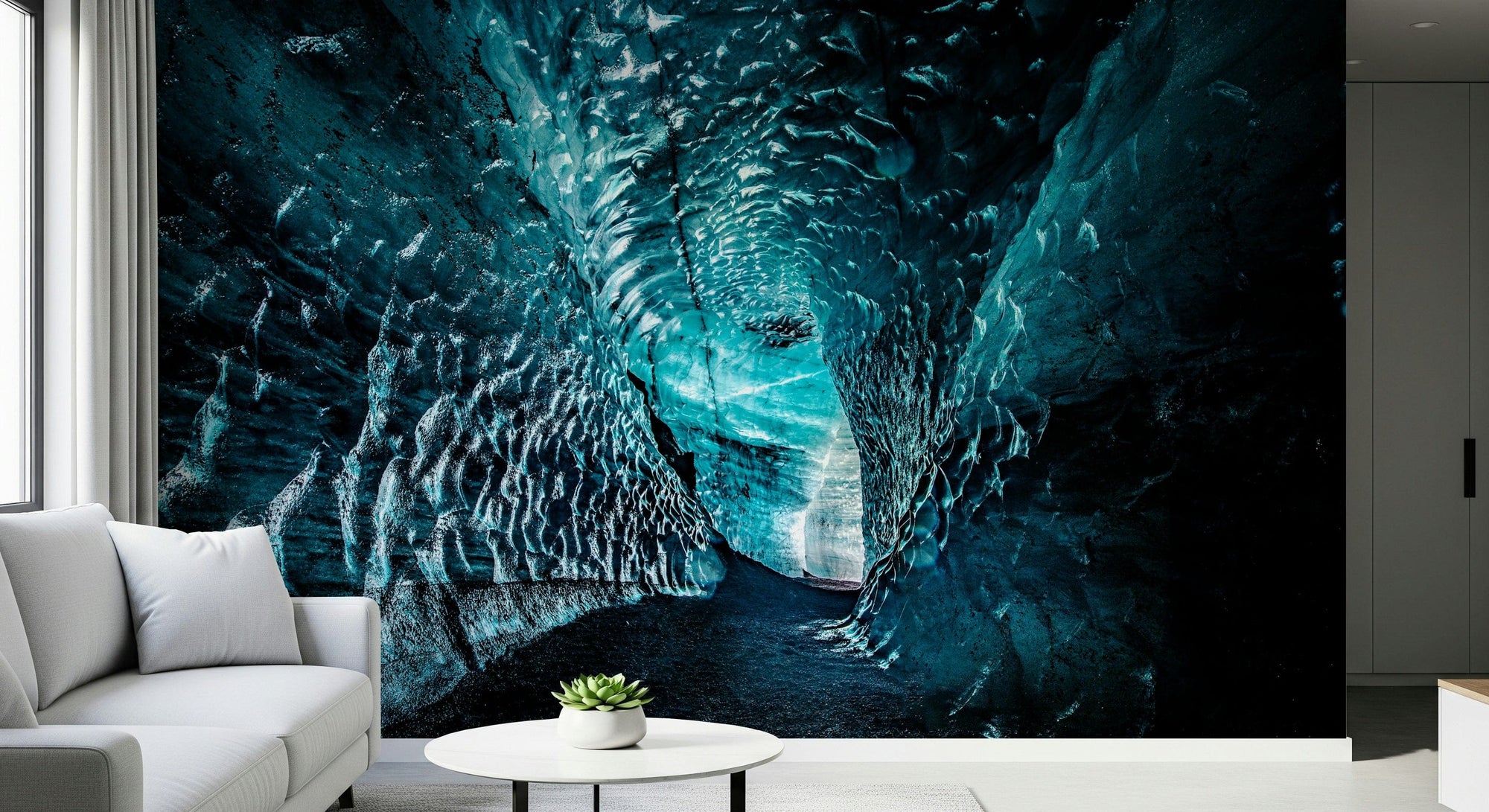Arctic Cavern wallpaper mural of a glowing turquoise ice cave behind a white sofa in a modern living room