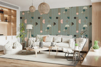 Art Deco Geometric Harmony wallpaper in sage deco shapes behind a white sofa with woven pendants and beanbag chair