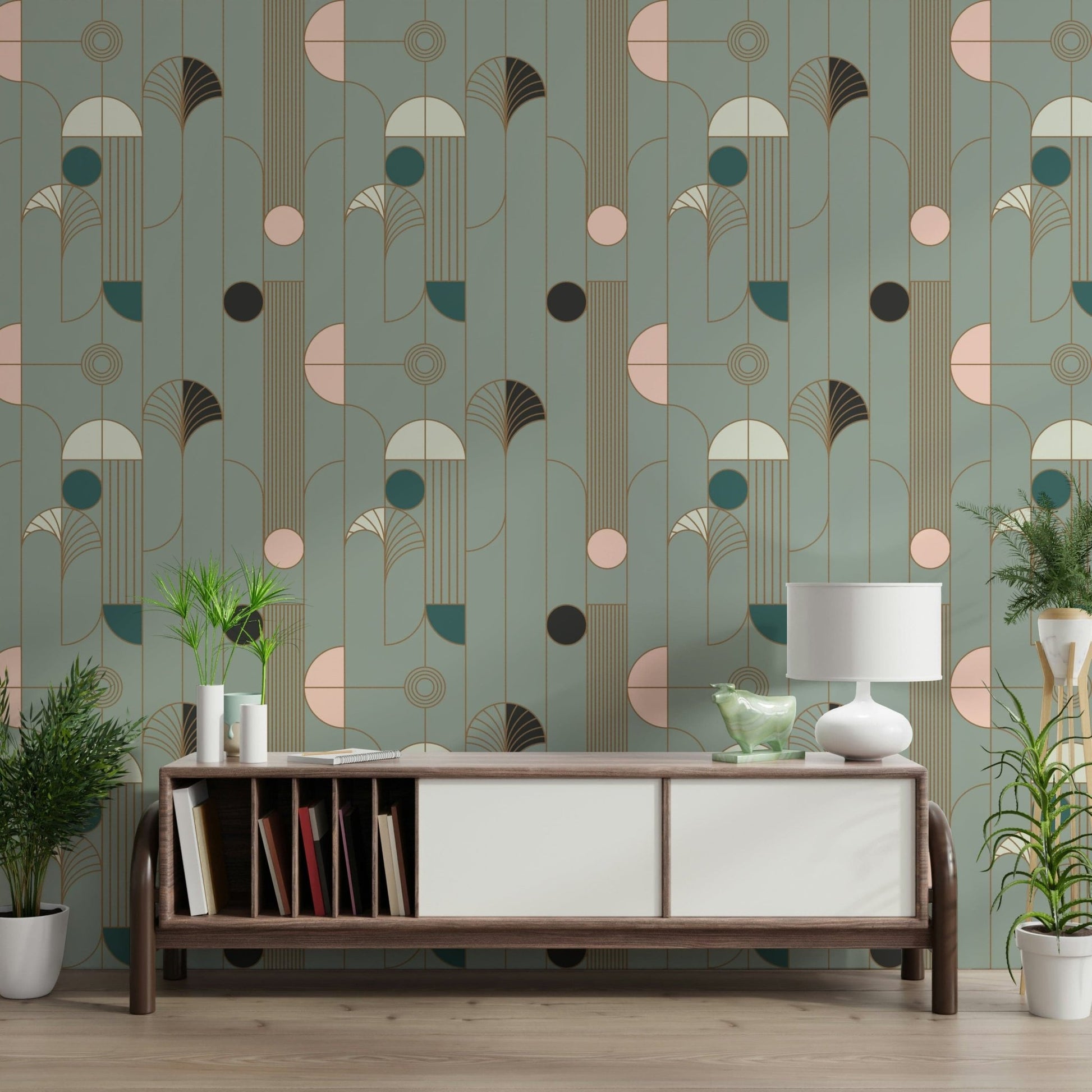 Art Deco Geometric Harmony wallpaper in sage and blush deco shapes behind a walnut sideboard with white lamp and ferns