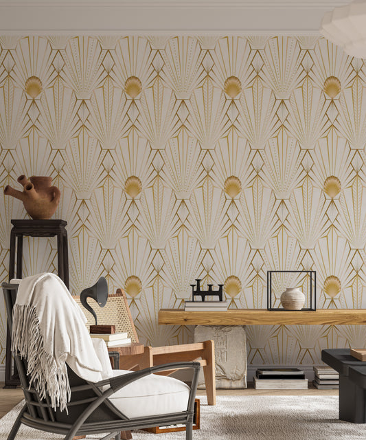 Art Deco Gold Radiance wallpaper in cream and gold behind a cane armchair and wood bench in a living room