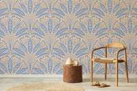 Artdeco Blue Palm Wallpaper in a lounge area with a wooden chair and jute rug using peel and stick fabric.
