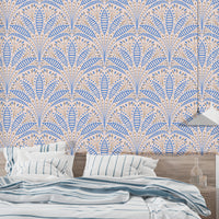 Luxury Artdeco Blue Palm Wallpaper in a bedroom with striped pillows using self adhesive backing for an easy update.