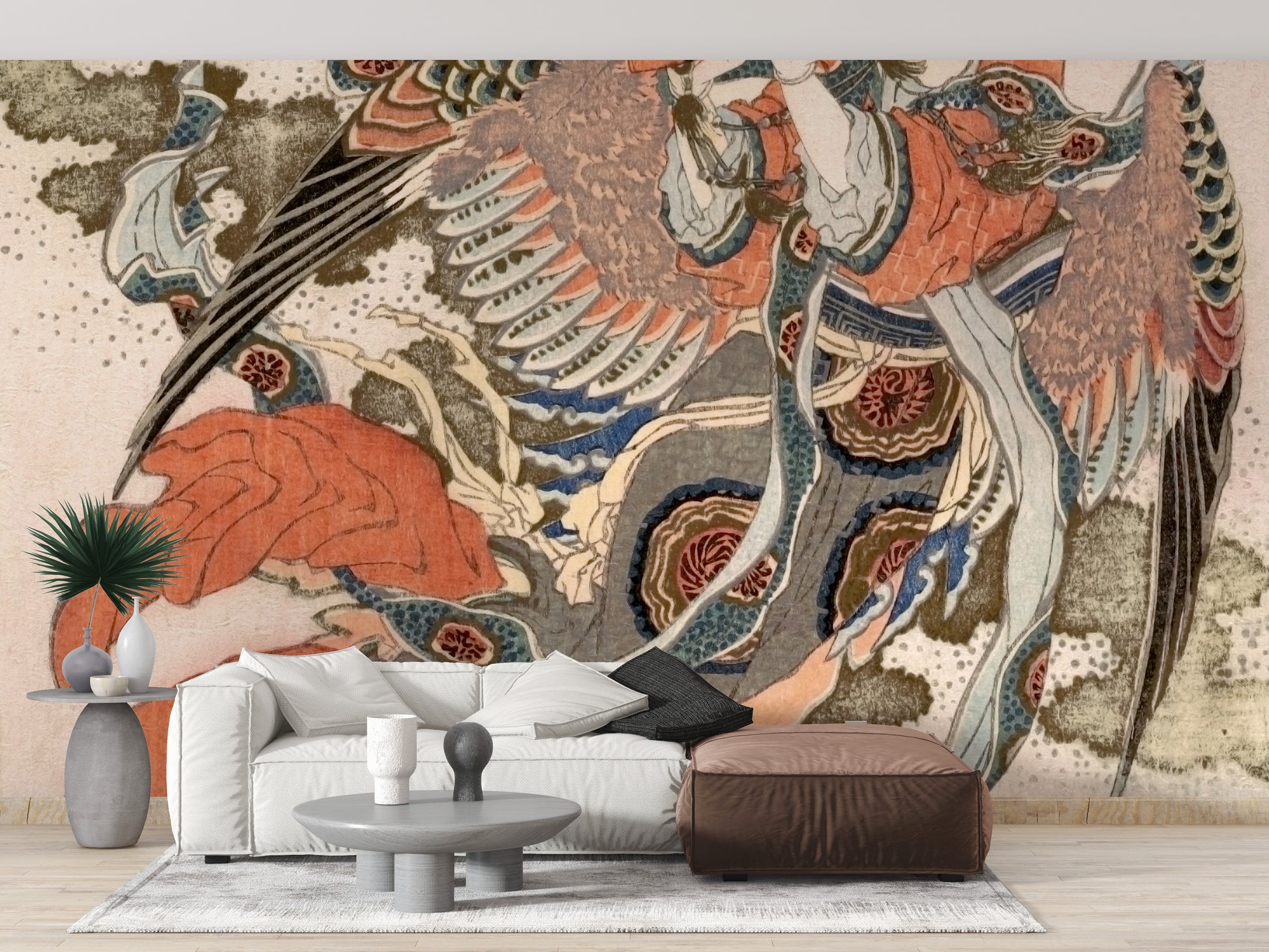 Asian Angel wallpaper mural in terracotta and blue tones above a white sofa and brown leather ottoman in a living room