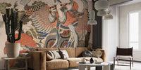 Asian Angel wallpaper mural of a flute-playing celestial figure on a phoenix behind a camel velvet sofa and cactus