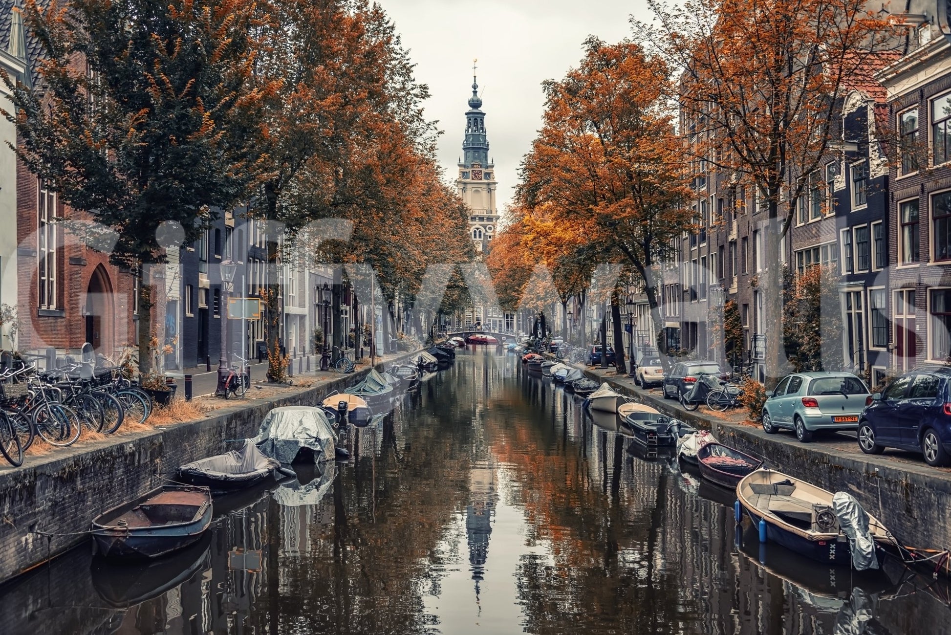 Autumn Canal Charm wallpaper mural close-up of an Amsterdam canal lined with orange autumn trees, boats and a bell tower