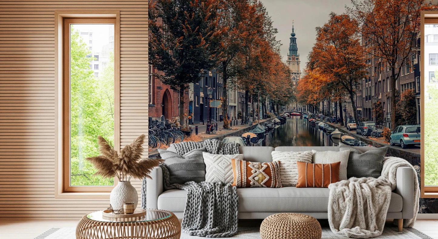 Autumn Canal Charm wallpaper mural of an autumn canal behind a grey sofa with boho pillows in a cozy living room