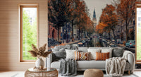 Autumn Canal Charm wallpaper mural of an autumn canal behind a grey sofa with boho pillows in a cozy living room
