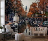 Autumn Canal Charm wallpaper mural of an autumn canal beside a white crib and striped rocking chair in a nursery