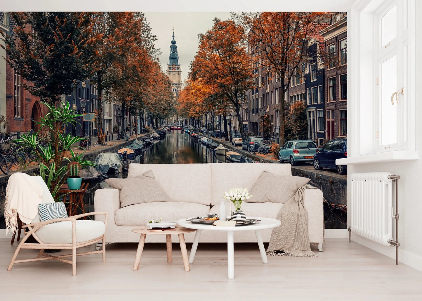 Autumn Canal Charm wallpaper mural of an autumn canal behind a cream sofa and wood-frame armchair in a living room