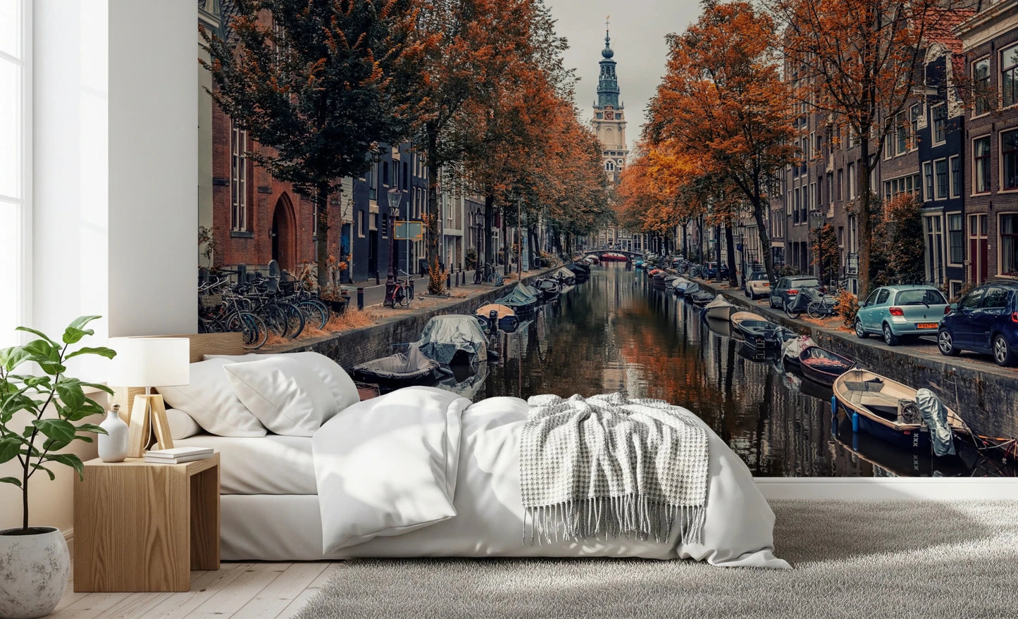 Autumn Canal Charm wallpaper mural of an Amsterdam canal with orange autumn trees above a white bed in a bedroom