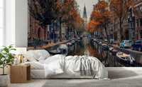 Autumn Canal Charm wallpaper mural of an Amsterdam canal with orange autumn trees above a white bed in a bedroom