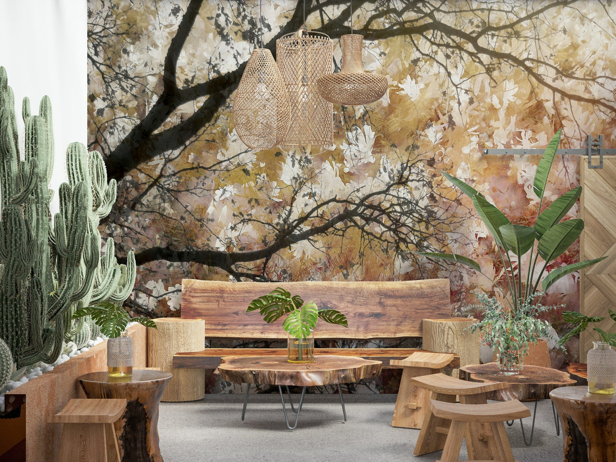 Autumnal Canopy wallpaper mural of golden leafy branches over a live-edge wood bench and cacti in a lounge