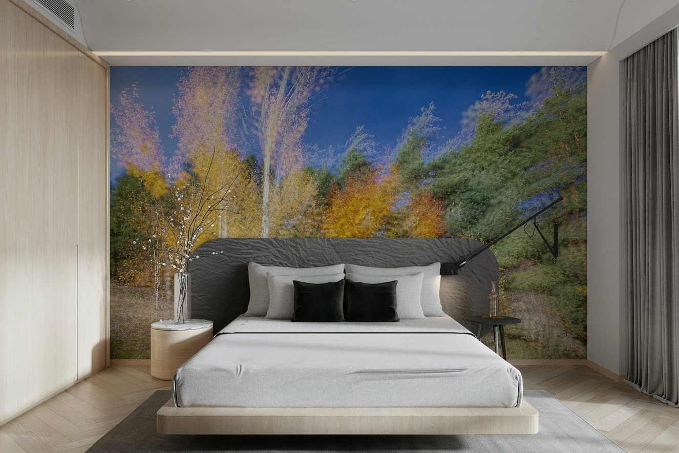 An abstract wall mural showing a forest with a colorful motion blur effect.

