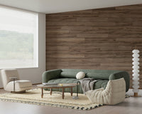 Barn Wood Beauty wallpaper mural in brown wood planks behind a green sofa and round wood coffee table