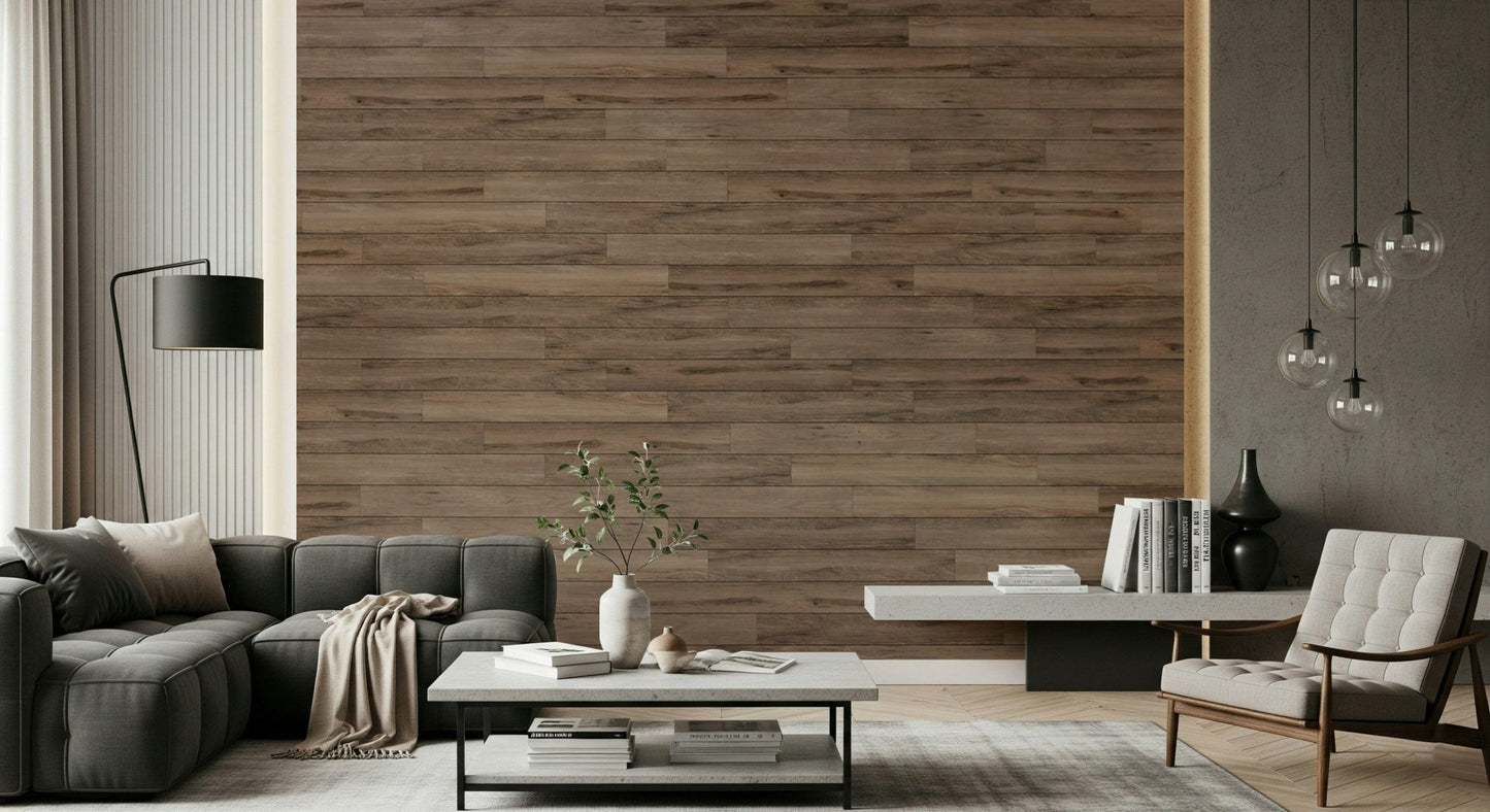 Barn Wood Beauty wallpaper mural in brown wood planks behind a dark gray sectional and white armchair