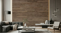 Barn Wood Beauty wallpaper mural in brown wood planks behind a dark gray sectional and white armchair