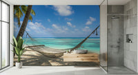 Beach Hammock Haven wallpaper mural of a hammock over a lagoon beside a glass walk-in shower in a grey-tiled bathroom