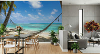 Beach Hammock Haven wallpaper mural of a hammock over a beach behind a black dining table beside a grey sofa lounge