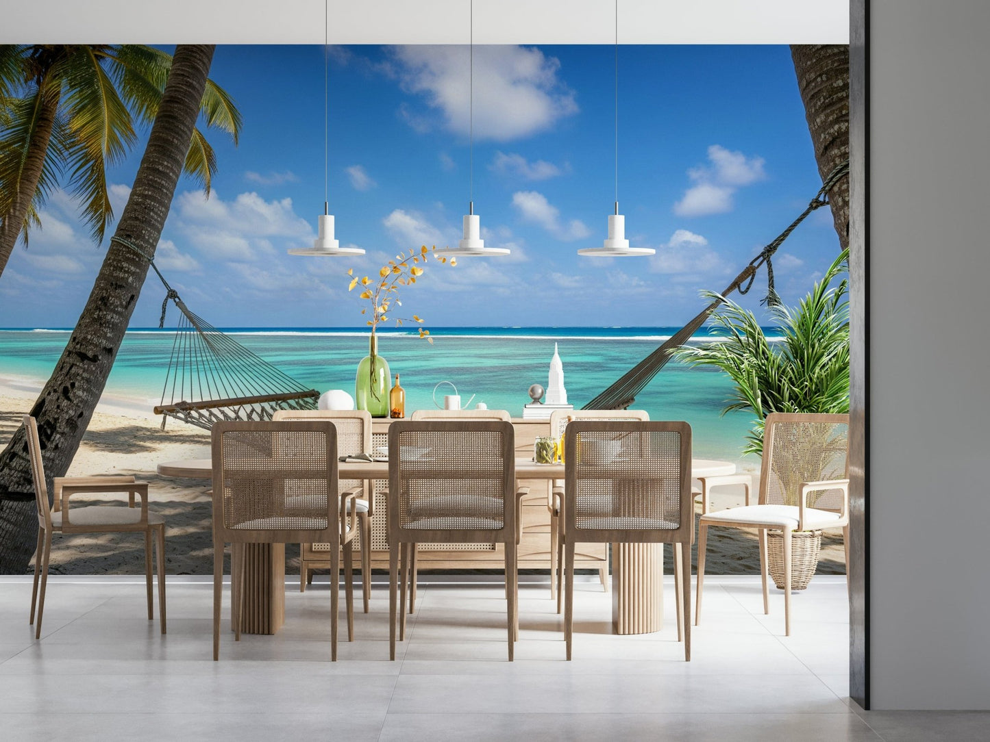 Beach Hammock Haven wallpaper mural of a hammock between palms over a turquoise lagoon behind a light wood dining table with cane chairs