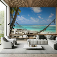 Beach Hammock Haven wallpaper mural of a hammock over a turquoise sea behind a grey sofa and cream armchairs in a living room