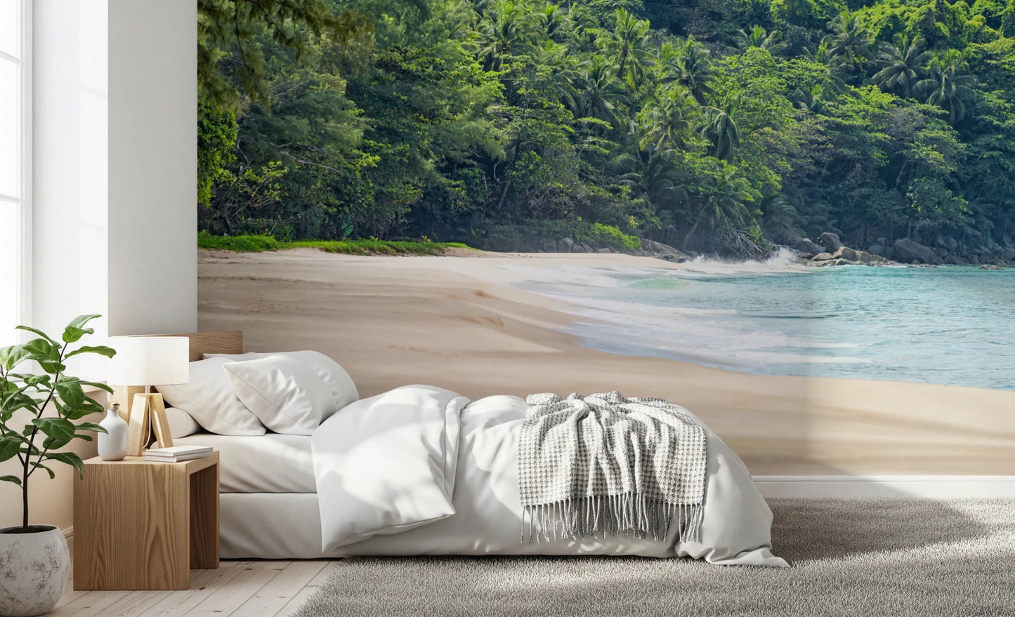 Beach Haven wall mural of a secluded beach and lush jungle behind a white bed and wood nightstand in a bedroom