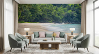 Beach Haven wall mural of a jungle cove behind a white sofa flanked by sage green armchairs and twin lamps