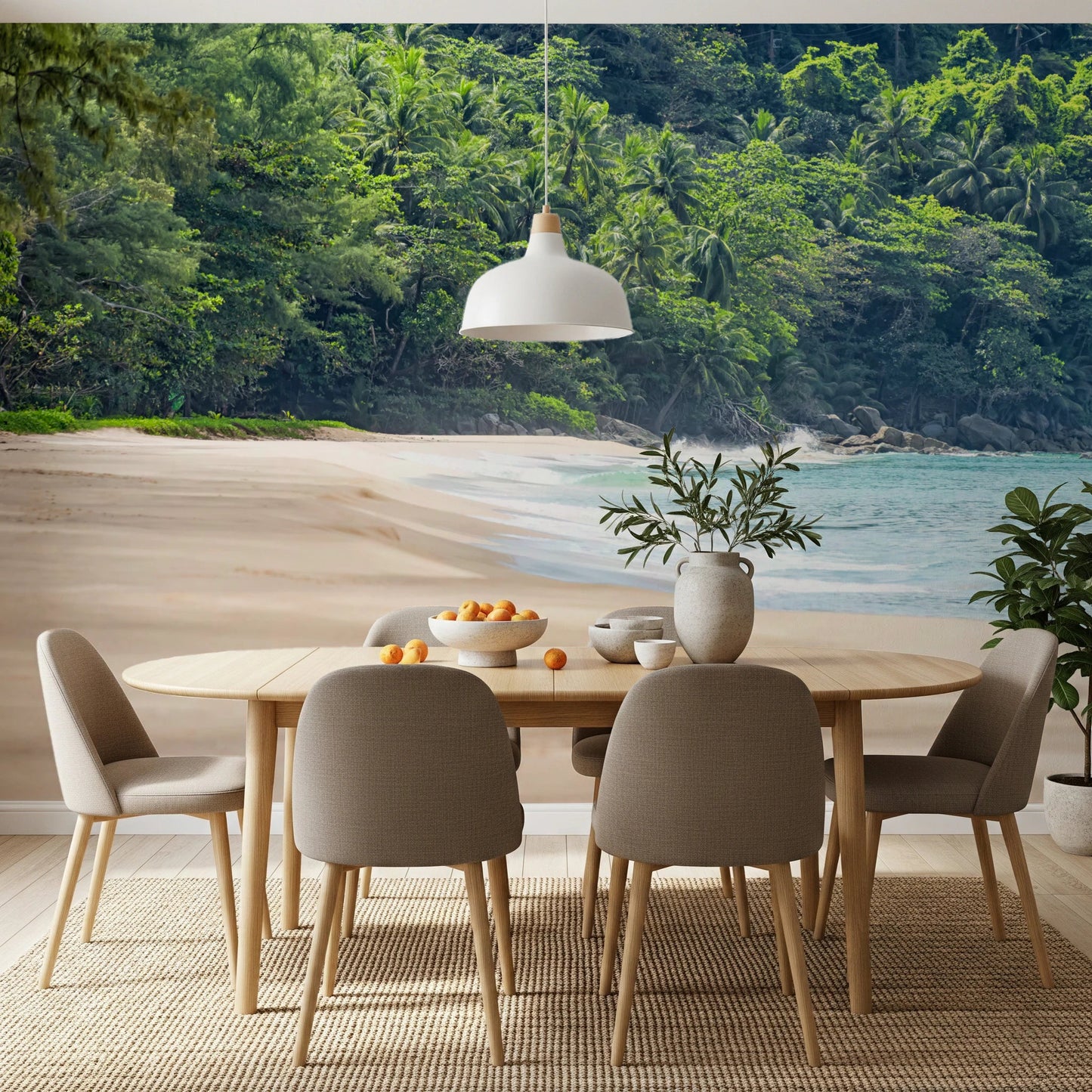 Beach Haven wall mural of a jungle-backed beach behind an oval wood dining table and taupe chairs
