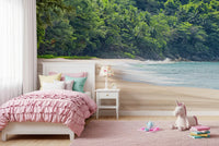 Beach Haven wall mural of a jungle beach in a girls room with a pink ruffled bed and unicorn plush toy