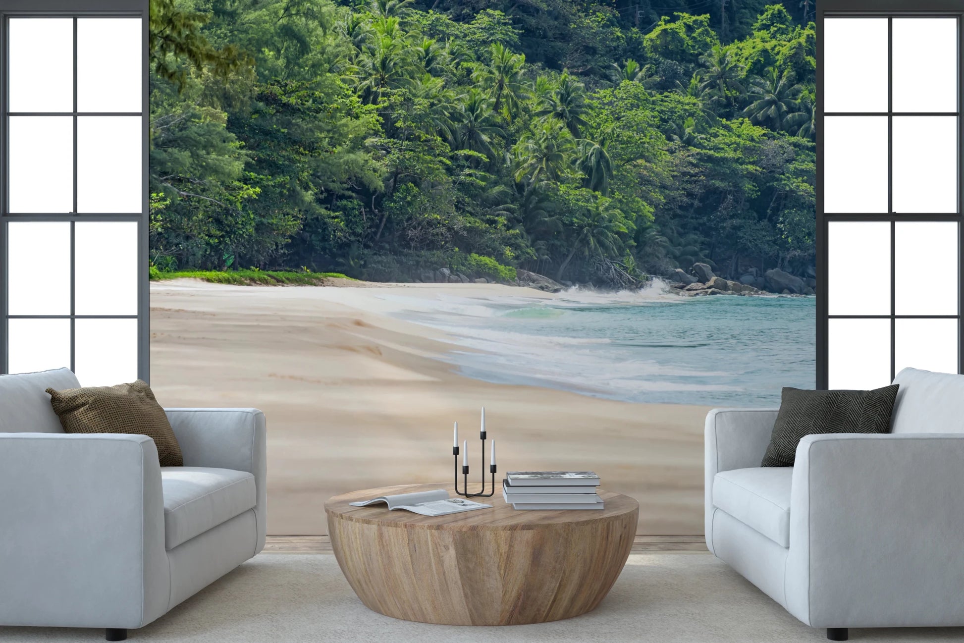 Beach Haven wall mural of pale sand and green jungle behind two white armchairs and a round wood table
