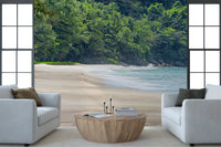 Beach Haven wall mural of pale sand and green jungle behind two white armchairs and a round wood table