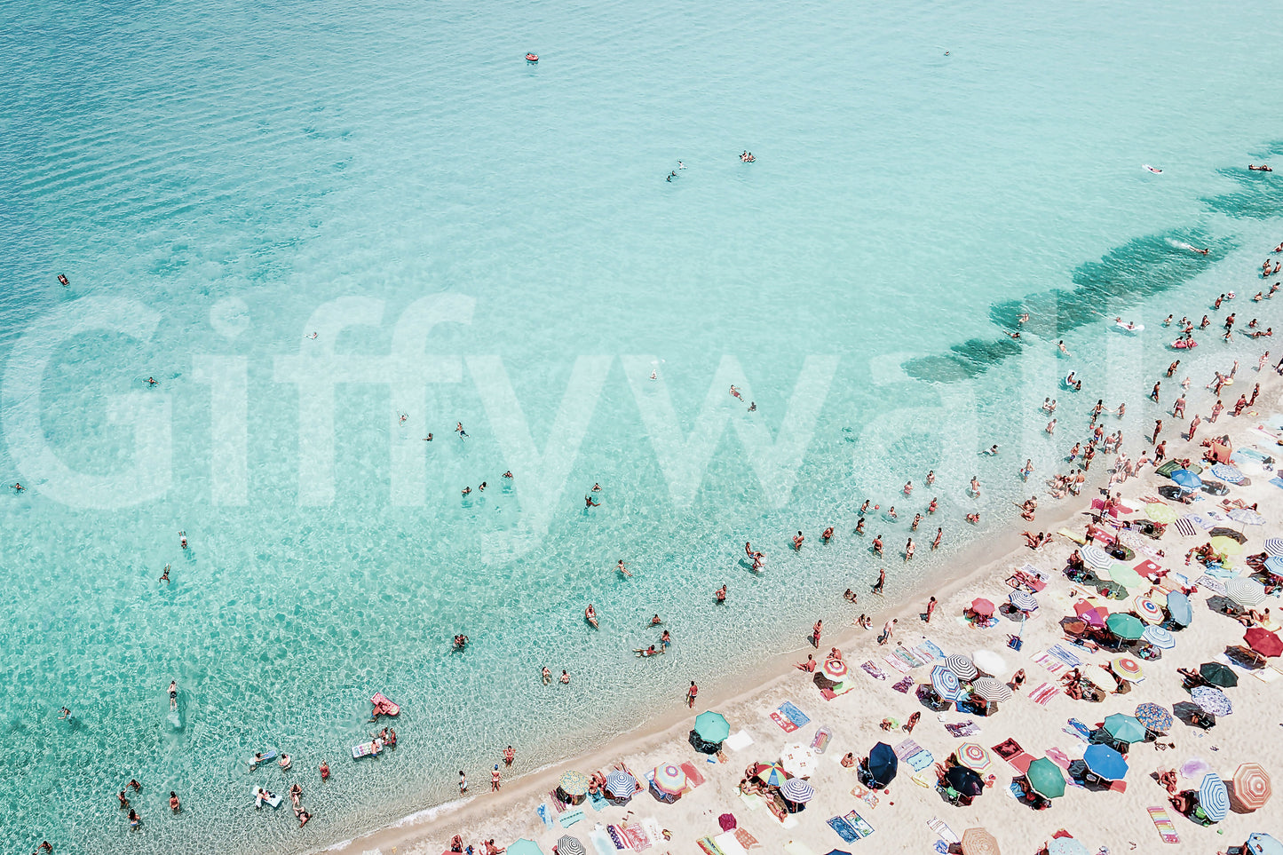 Fun beach scene with people and surf in the Beach People mural.

