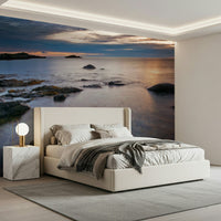 Apartment bedroom wall decor with twilight beach mural, warm sunset color accents, clean look