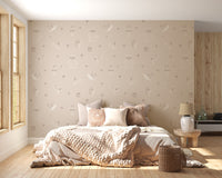 Beige Baby Forest Friends wallpaper with line-drawn bears foxes and rabbits behind a knit-bedded bed in a bedroom