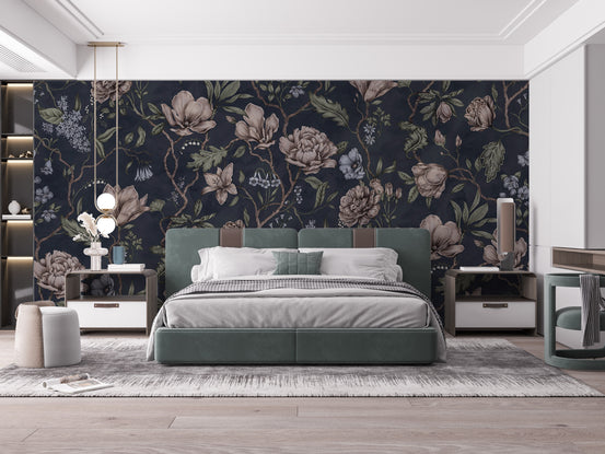 Belinda Dark Blue Garden wallpaper with blush magnolias and peonies behind a sage upholstered bed in a bedroom