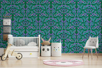 Berry Branch Symphony wallpaper behind a white crib and animal-face chair in a green nursery